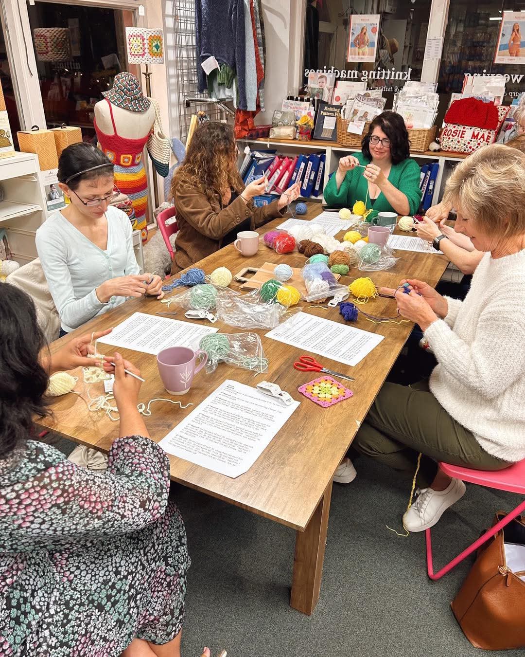 group of people crocheting/knitting
